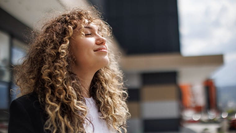 Young woman looking happy and relaxed.