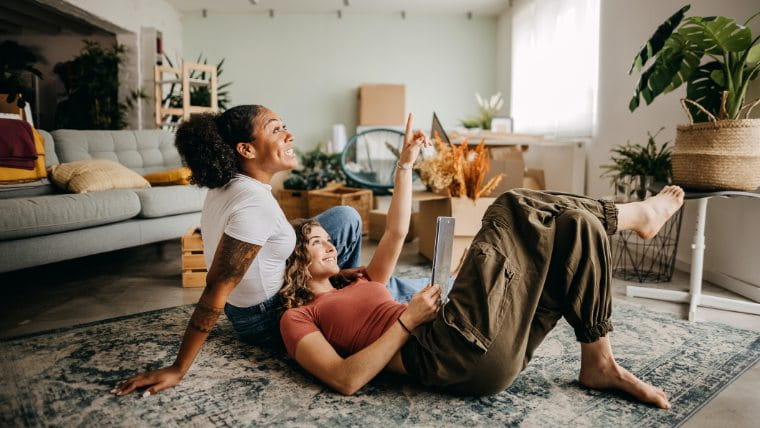 Two women hanging out in apartment.