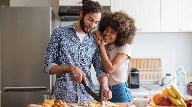 Young couple cooking together in the kitchen.