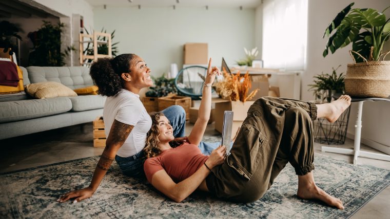 Two women hanging out in apartment.